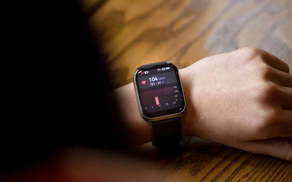 Person checking their pulse on a smartwatch